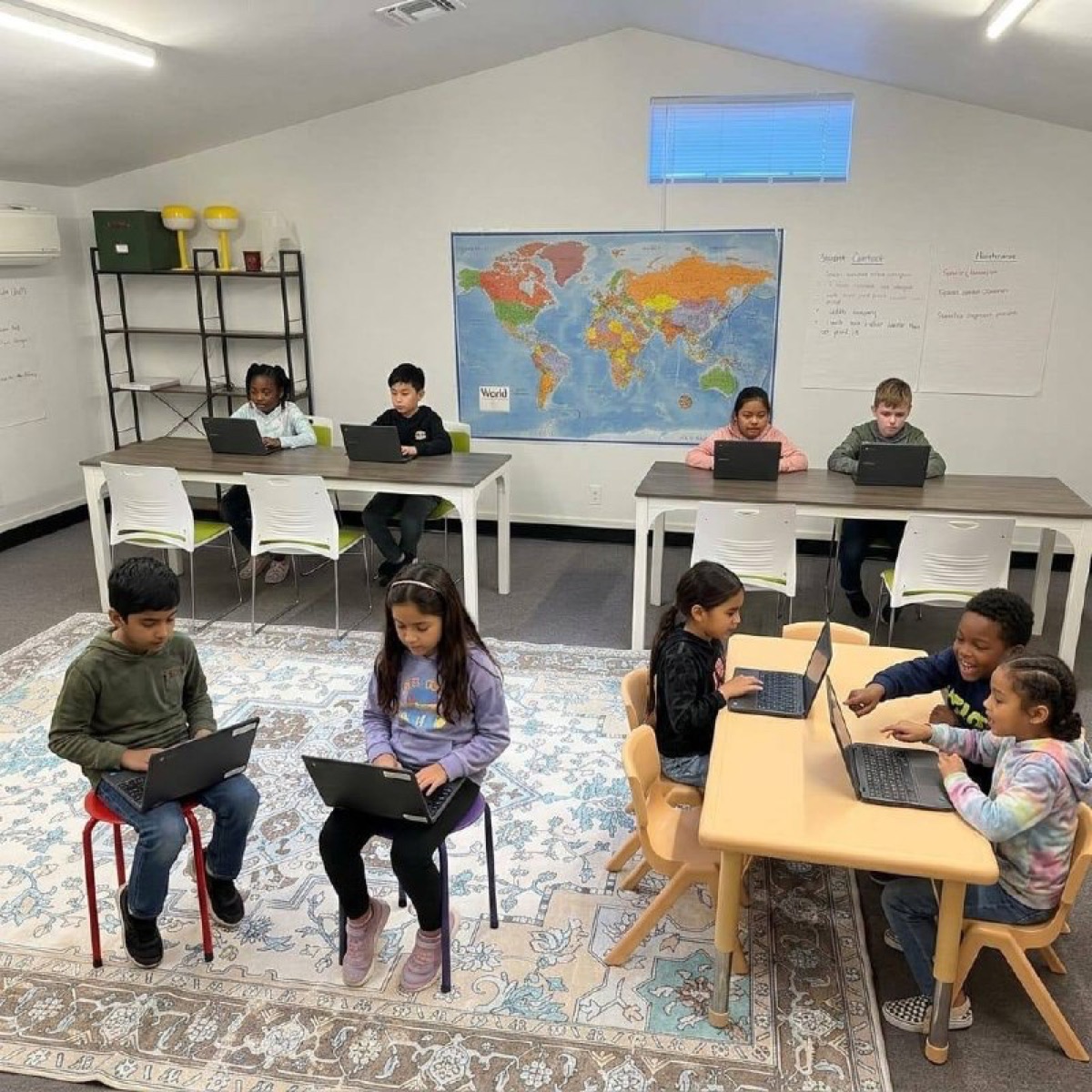 Kids working independently on Chromebooks at Acton Academy